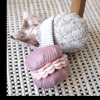 Dog Dish Lambwolf Cookie enrichment set featuring a plush pink macaroon and a textured madeleine dog puzzle toy.