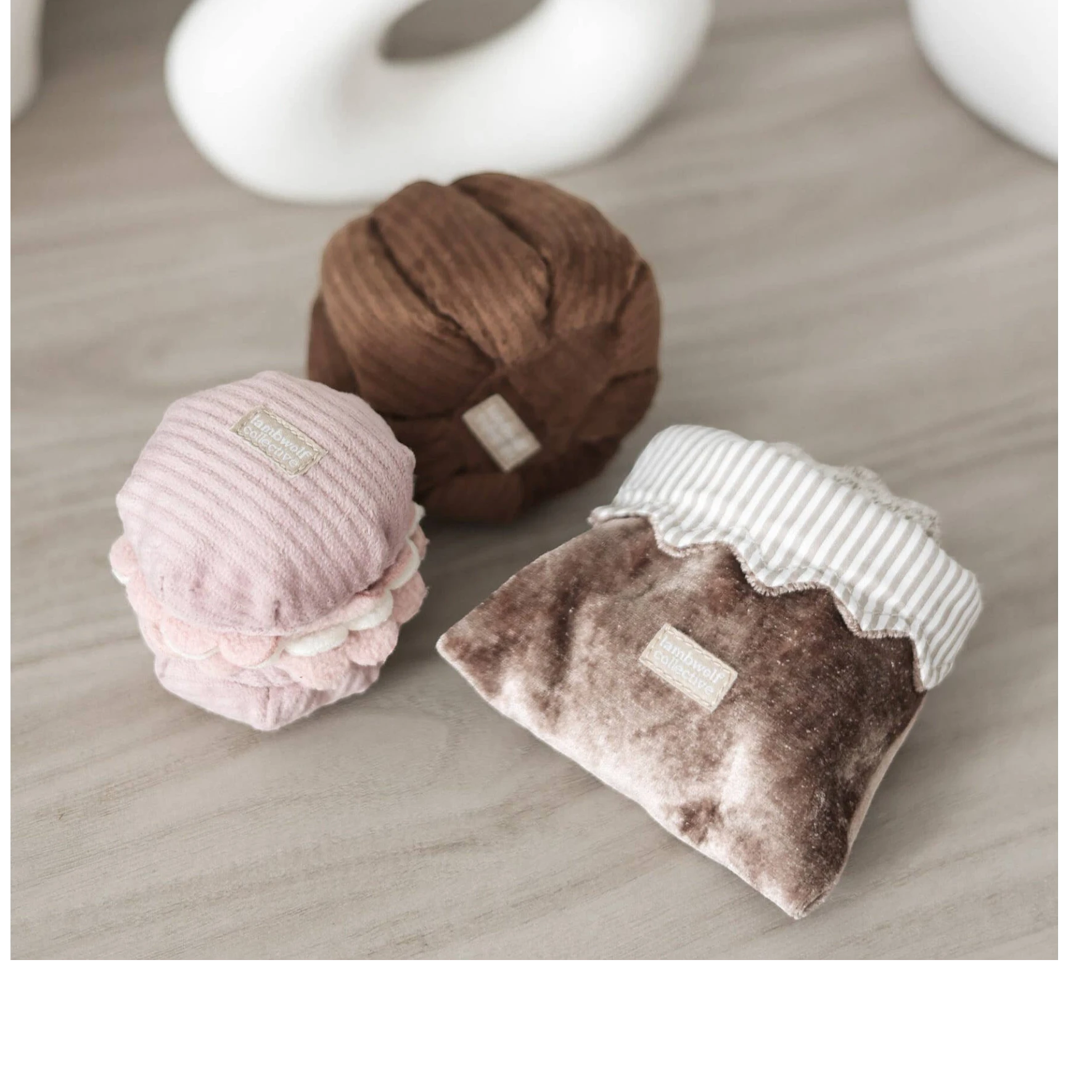 Dog Dish Lambwolf Cookie enrichment set featuring plush pastry-themed snuffle toys for small dogs on a wooden surface.