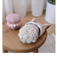 Dog Dish Lambwolf Cookie enrichment set with a pink macaroon and a textured brown madeleine dog puzzle toy.