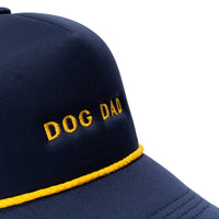 Dog Dish navy trucker hat with yellow Dog Dad embroidery and matching yellow rope detail on the brim