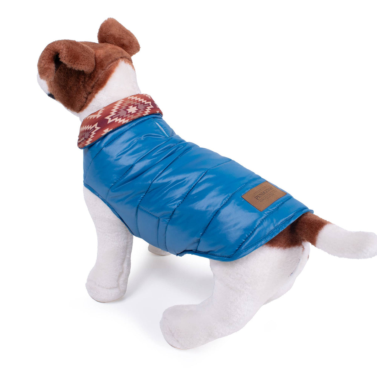 Dog Dish Pendleton Pagosa Springs reversible blue quilted puffer dog coat on a plush toy dog