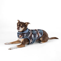 Dog Dish Pendleton reversible puffer dog coat in Wyeth Trail pattern worn by a small dog on a white background