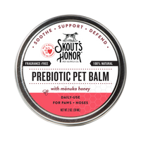 Dog Dish Skouts Honor Prebiotic Pet Balm in a round metal tin for soothing dry dog and cat paws and noses.