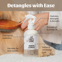 Dog Dish Skout's Honor probiotic detangler spray bottle being used to brush a dog's coat with a wooden brush.