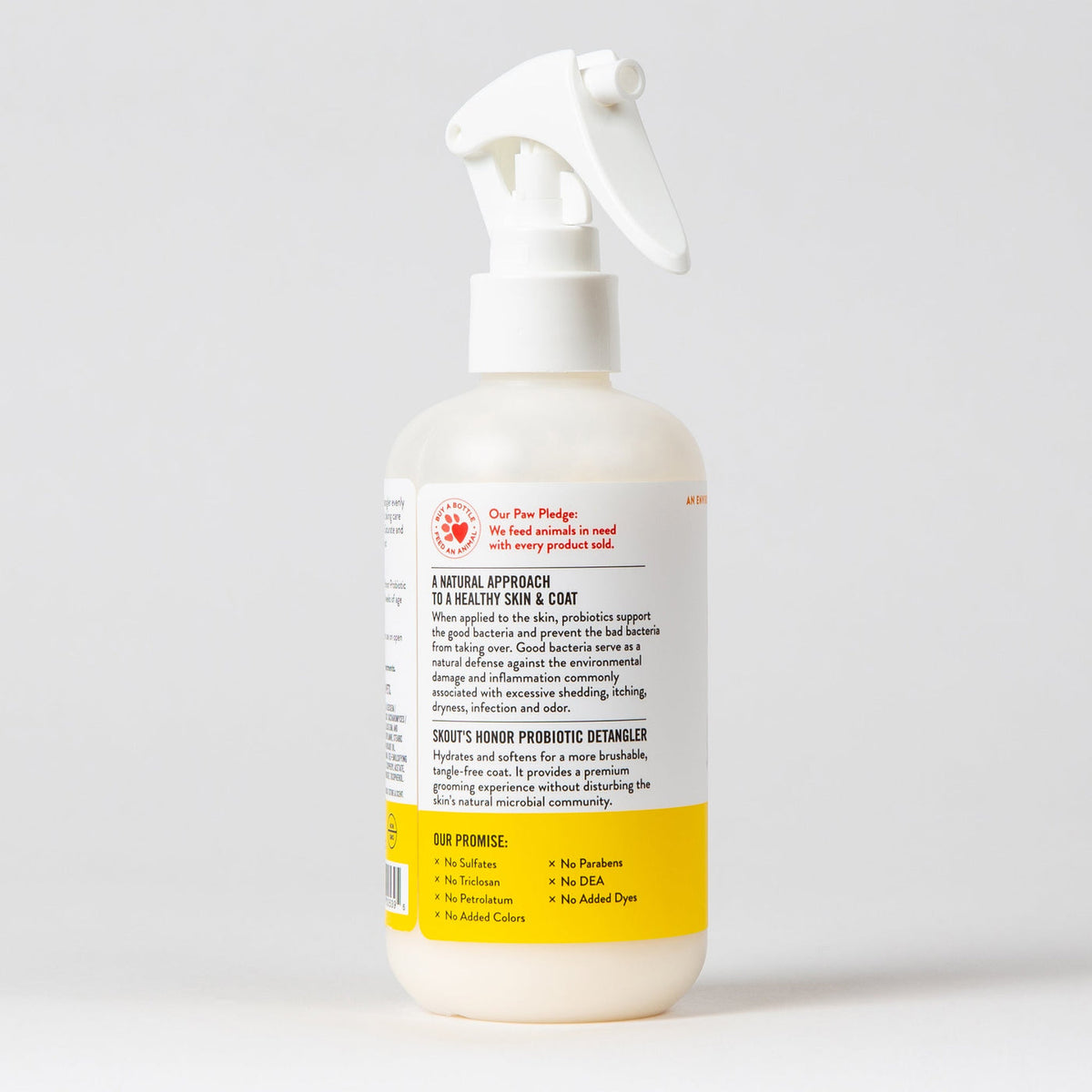 Dog Dish Skout's Honor probiotic honeysuckle detangler spray bottle for pet grooming on a white background.