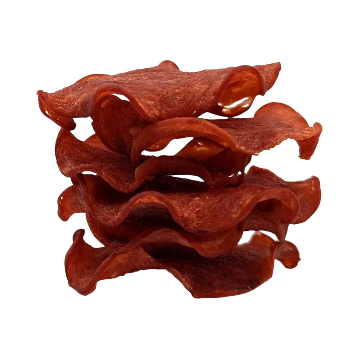 Dog Dish Wild Meadow Farms turkey crispy chips stacked in a wavy, thin-sliced pile against a black background.