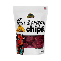 Dog Dish Wild Meadow Farms beef crispy chips in a white resealable pouch featuring a colorful cow illustration.
