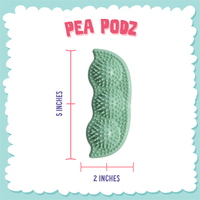 SnugArooz Pea Podz green dog chew toy showing individual pea squeakers removed from fabric pod casing