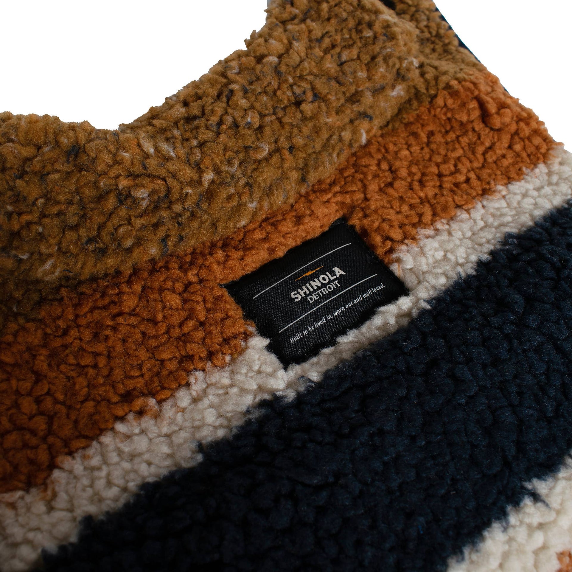 Close-up detail of genuine shearling lining interior in brown Shinola Pet adjustable barn style dog coat