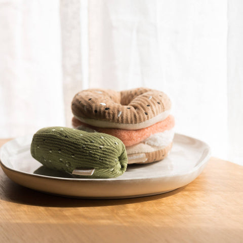 Lambwolf Collective Bagel + Pickle Enrichment Toy set featuring plush cream bagel with removable pickle toy for dogs.