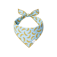 Rufflifepals Bananas dog bandana featuring a yellow banana print pattern on a flat lay display.