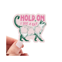 Yarnival Hold On I See a Cat vinyl sticker featuring bold text and playful cat-themed graphic design.
